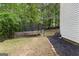 Backyard view featuring a trampoline, playset, and landscaped yard at 190 Ridgecrest Dr, Fayetteville, GA 30215