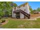 Backyard view of a two-story home with a deck and a landscaped yard at 190 Ridgecrest Dr, Fayetteville, GA 30215