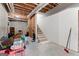 Unfinished basement with exposed beams, framing, and carpeted stairs at 190 Ridgecrest Dr, Fayetteville, GA 30215