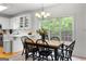A dining room with a table, black chairs, and a large window offering scenic views at 190 Ridgecrest Dr, Fayetteville, GA 30215