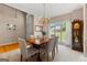 Dining room with a wooden table, chandelier lighting, and views of the backyard greenery at 190 Ridgecrest Dr, Fayetteville, GA 30215