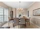 Elegant dining room with a chandelier, large window, and stylish seating for formal gatherings at 190 Ridgecrest Dr, Fayetteville, GA 30215