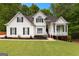 Charming two-story home featuring a manicured lawn, mature trees, and inviting front porch at 190 Ridgecrest Dr, Fayetteville, GA 30215