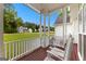 Covered porch featuring rocking chairs, offering a relaxing view of the manicured lawn and neighborhood at 190 Ridgecrest Dr, Fayetteville, GA 30215