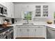 Bright kitchen with stainless steel appliances, white cabinets, and a window above the sink at 190 Ridgecrest Dr, Fayetteville, GA 30215