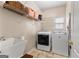 Functional laundry room with modern washer, dryer, and ample storage shelving at 190 Ridgecrest Dr, Fayetteville, GA 30215