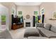 Bright living room features fireplace, large windows, and a comfortable gray sectional sofa at 190 Ridgecrest Dr, Fayetteville, GA 30215