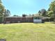 View of the home from the spacious backyard with a screened-in patio at 8315 Ridge Rd, Fairburn, GA 30213