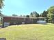 Expansive backyard with a well-maintained lawn and a screened porch at 8315 Ridge Rd, Fairburn, GA 30213
