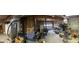 Panorama of an unfinished basement leading to a garage and storage areas at 8315 Ridge Rd, Fairburn, GA 30213