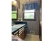 Bathroom with a sink vanity and wallpapered walls at 8315 Ridge Rd, Fairburn, GA 30213