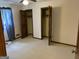 Bedroom features carpet flooring, a ceiling fan, and bi-fold closet doors at 8315 Ridge Rd, Fairburn, GA 30213