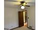 Bedroom boasts carpet flooring, a ceiling fan, and wood trim at 8315 Ridge Rd, Fairburn, GA 30213