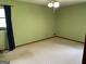 Bedroom features green walls, carpet flooring, and a ceiling fan with lighting at 8315 Ridge Rd, Fairburn, GA 30213