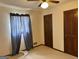 Cozy bedroom featuring neutral carpeting, a ceiling fan, and natural light from the window at 8315 Ridge Rd, Fairburn, GA 30213