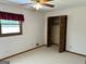 Bedroom featuring neutral carpeting, a ceiling fan, and closet with folding doors at 8315 Ridge Rd, Fairburn, GA 30213