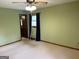 Empty bedroom boasts ample natural light, carpet flooring, and green walls at 8315 Ridge Rd, Fairburn, GA 30213