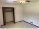 Bedroom featuring neutral carpeting, a ceiling fan, and closet with folding doors at 8315 Ridge Rd, Fairburn, GA 30213