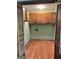 Empty laundry room with wooden floor and storage cabinets at 8315 Ridge Rd, Fairburn, GA 30213