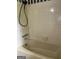 Shower boasts neutral tile, chrome fixtures, and a handheld shower head at 8315 Ridge Rd, Fairburn, GA 30213