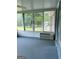 Enclosed sunroom with air conditioner, carpeted floor and a view of the yard at 8315 Ridge Rd, Fairburn, GA 30213