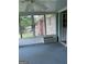 Enclosed sunroom with air conditioner, carpeted floor and a view of the yard at 8315 Ridge Rd, Fairburn, GA 30213