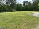 Expansive, well-maintained yard with lush green grass, mature trees, and a tranquil, natural setting at 8315 Ridge Rd, Fairburn, GA 30213