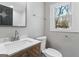 This bathroom features a marble countertop, modern fixtures, and a wood grain vanity, offering style and functionality at 3650 Adkins Nw Rd, Atlanta, GA 30331