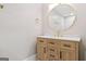 Bathroom with wood vanity, gold hardware, and an elegant round mirror at 3650 Adkins Nw Rd, Atlanta, GA 30331
