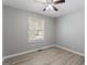 A cozy bedroom features hardwood floors, a ceiling fan, and neutral paint for a calming space at 3650 Adkins Nw Rd, Atlanta, GA 30331