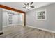 Spacious bedroom featuring wood-look floors, a ceiling fan, and natural light at 3650 Adkins Nw Rd, Atlanta, GA 30331