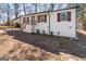Stylish exterior showcasing the white brick, wooden accents, and front yard of the property at 3650 Adkins Nw Rd, Atlanta, GA 30331