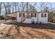 Charming one-story home with white brick, wood shutters, a carport, and a bright blue front door at 3650 Adkins Nw Rd, Atlanta, GA 30331