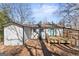A charming home showcases a deck, modern siding, a bright blue front door and manicured landscaping at 3650 Adkins Nw Rd, Atlanta, GA 30331