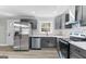 Modern kitchen with stainless steel appliances, gray cabinets, and stylish backsplash at 3650 Adkins Nw Rd, Atlanta, GA 30331