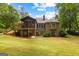 Expansive backyard featuring a screened porch, lush lawn, and mature trees offers a private outdoor retreat at 40 High St, Sharpsburg, GA 30277