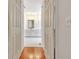 Bathroom view through doorway, showing white vanity and mirror at 40 High St, Sharpsburg, GA 30277