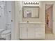 Well-lit bathroom features vanity with a large mirror and an adjacent toilet at 40 High St, Sharpsburg, GA 30277