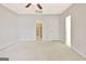 Spacious bedroom with a ceiling fan, multiple entry points and carpeted floor at 40 High St, Sharpsburg, GA 30277