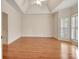 Spacious bedroom with hardwood floors, tray ceiling, and large windows with plantation shutters at 40 High St, Sharpsburg, GA 30277