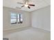 Spacious carpeted bedroom with a ceiling fan and a window view to the outdoors at 40 High St, Sharpsburg, GA 30277