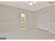 Bright carpeted bedroom featuring a large closet and a doorway to bathroom at 40 High St, Sharpsburg, GA 30277
