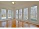Bedroom with hardwood floors and four large windows providing natural light and a view of the outdoors at 40 High St, Sharpsburg, GA 30277