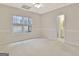 Carpeted bedroom with a large window and doorway to an en-suite bathroom at 40 High St, Sharpsburg, GA 30277