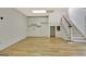 Open bonus room featuring a wet bar, staircase, and wood floors at 40 High St, Sharpsburg, GA 30277