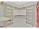 Walk in closet with shelves and hanging rods for ample storage space at 40 High St, Sharpsburg, GA 30277