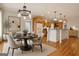 Well-lit dining room with a modern chandelier open to the kitchen at 40 High St, Sharpsburg, GA 30277