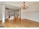 Open-concept dining area with hardwood floors and traditional chandelier lighting at 40 High St, Sharpsburg, GA 30277