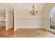 Spacious dining room with hardwood floors, chandelier, and an arched stained-glass window at 40 High St, Sharpsburg, GA 30277
