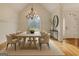 Bright dining room featuring chandelier, modern furniture, vaulted ceilings, and decorative window at 40 High St, Sharpsburg, GA 30277